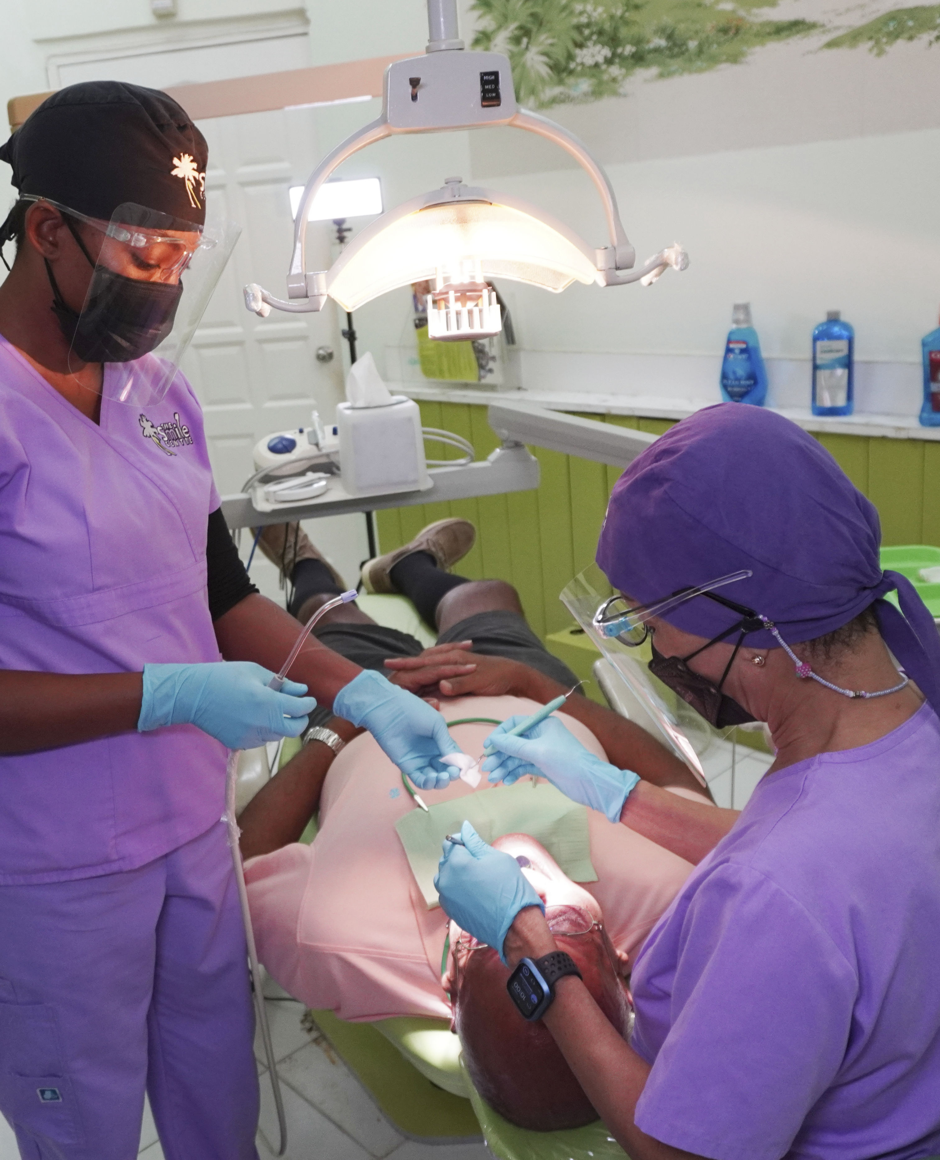 Dr. Hope and dental technician attending to a patient