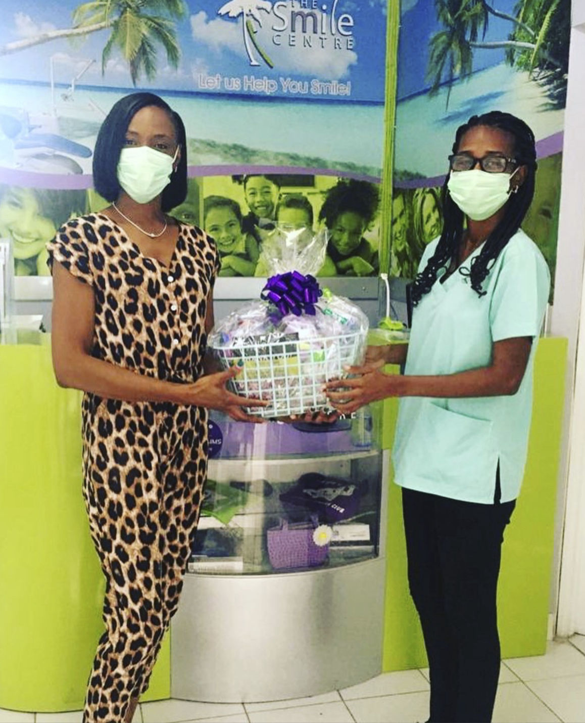 Staff member handing gift basket to a customer